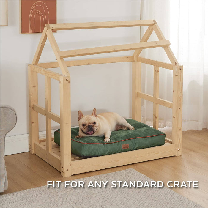 French Bulldog on deep green plush waterproof dog bed with brown piping, inside wooden crate.