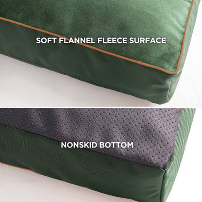 Plush waterproof dog bed features soft flannel fleece surface with orange piping and nonskid bottom for stability.