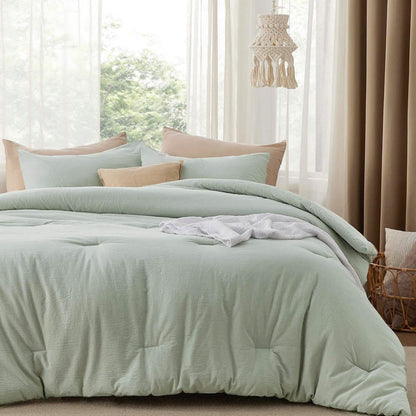 GentleSoft Prewashed Cotton Comforter Set in pale green with wrinkled texture and accent pillows on a bed.