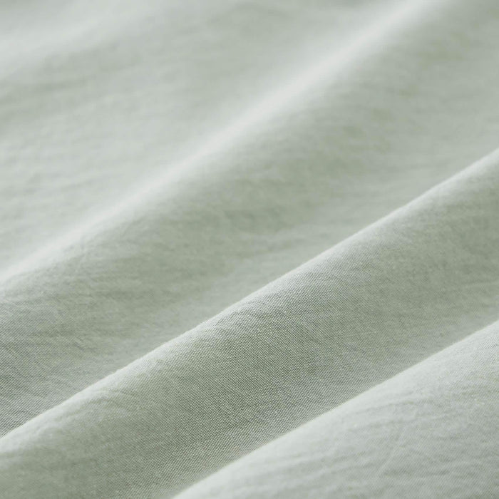 Pale green prewashed cotton fabric close-up, showing natural wrinkle texture of GentleSoft comforter.