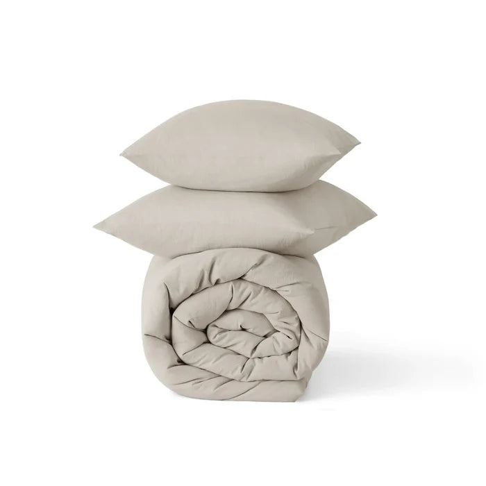 GentleSoft® prewashed cotton comforter set in beige, rolled comforter and two shams with natural wrinkles.