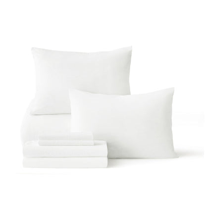 White prewashed down alternative bed-in-a-bag components: pillows and folded sheets.