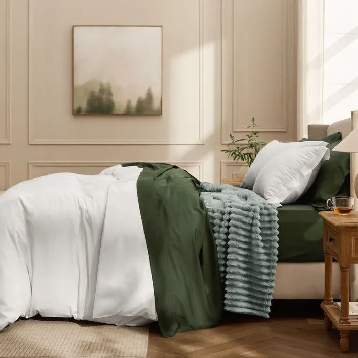 Rayon from bamboo modern cozy bundle: white duvet, forest green sheets, and textured grey blanket.