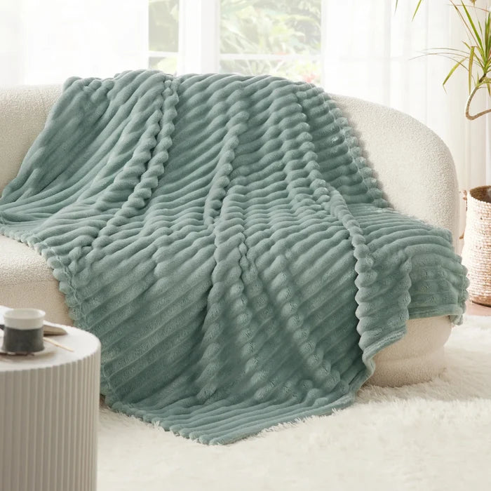 Soft teal blanket with ridged texture, part of a cozy bamboo rayon bundle.