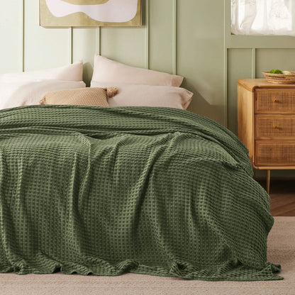Olive green GentleSoft cooling waffle blanket on bed. Bamboo-cotton blend, waffle texture.