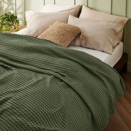GentleSoft olive green cooling waffle blanket on bed. Bamboo-cotton blend, lightweight, textured weave.