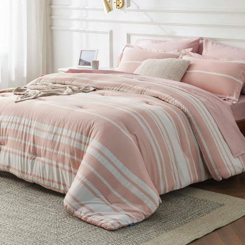GentleSoft pink and white striped reversible bed-in-a-bag comforter set shown on a made bed.