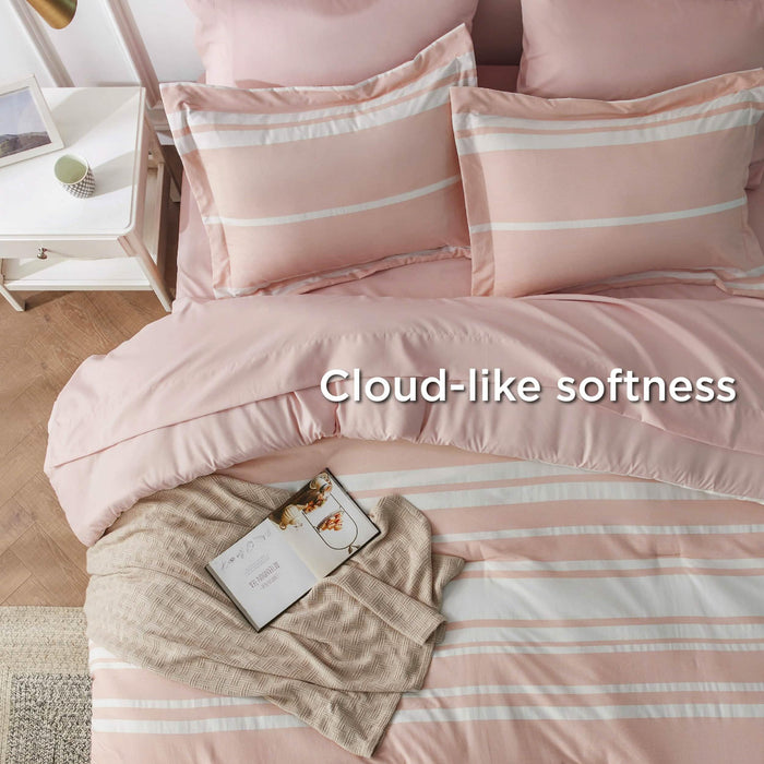 GentleSoft reversible cationic dyed bed-in-a-bag: pink and white striped comforter set on bed.