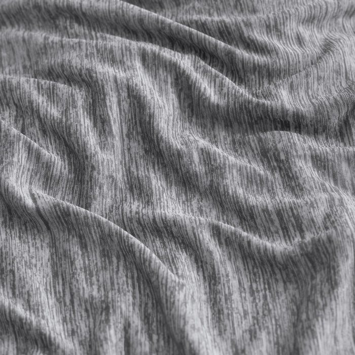Close-up of gray GentleSoft reversible cooling blanket fabric texture with subtle vertical striations, nylon material.