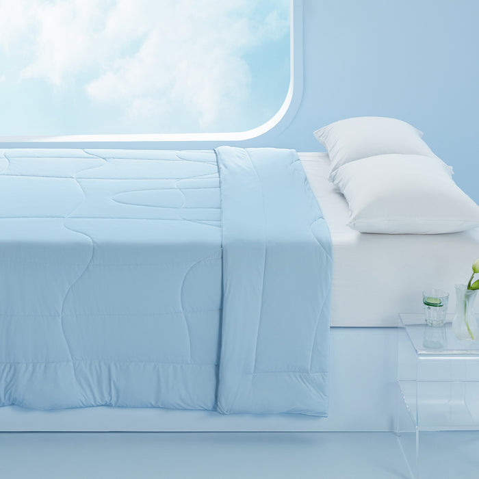 Soft light blue reversible cooling comforter with quilted pattern