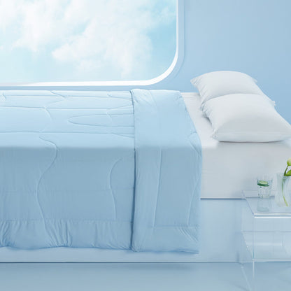 Soft light blue reversible cooling comforter with quilted pattern