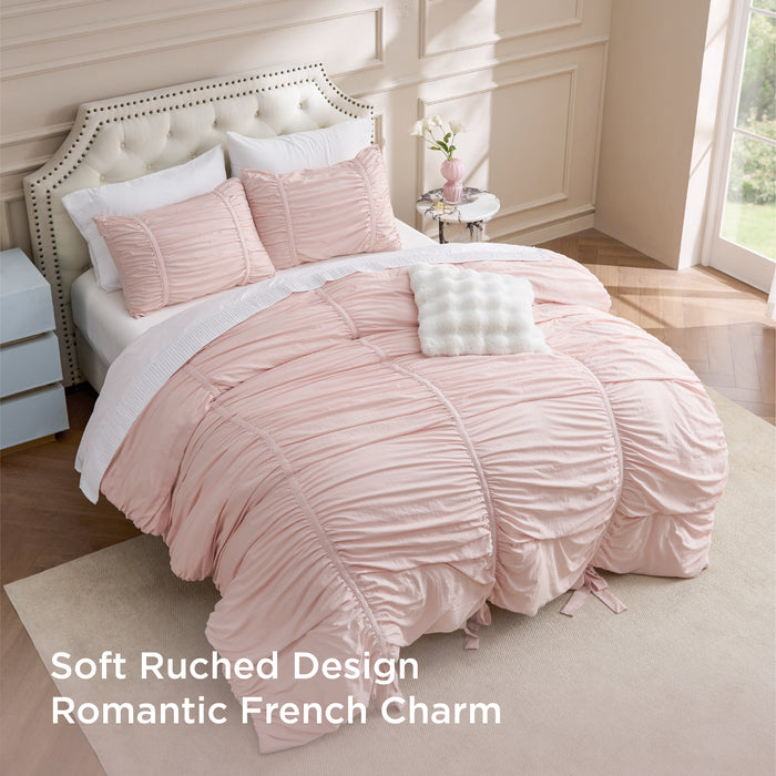 Pink ruched comforter set with bows, soft romantic French charm.