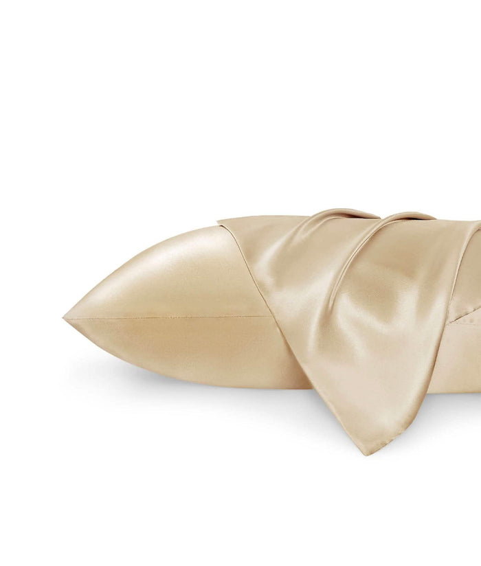 GentleSoft satin body pillowcase in light gold, showcasing smooth texture and soft drape on white background.