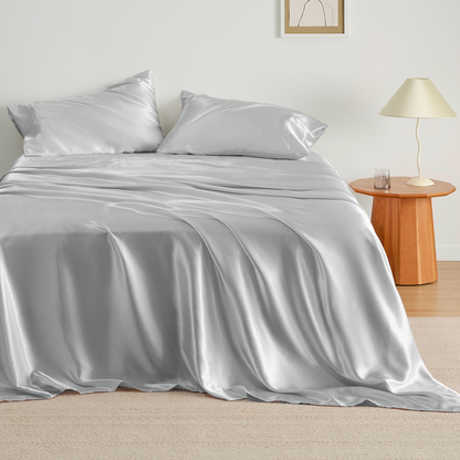 GentleSoft satin sheet set in pale silver, showcasing lustrous, silk-mimicking texture for skin and hair benefits.