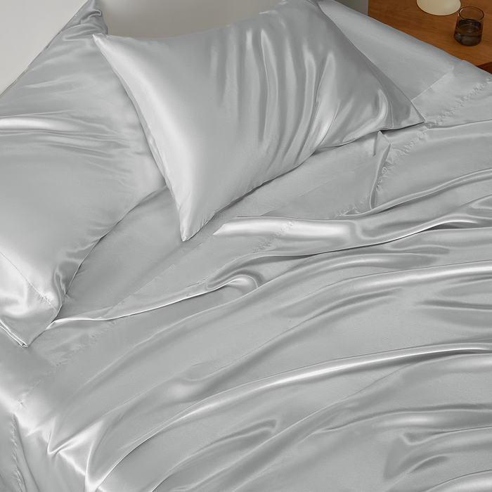 GentleSoft pale silver satin sheet set on bed, highlighting smooth, lustrous texture and soft feel for luxurious comfort.