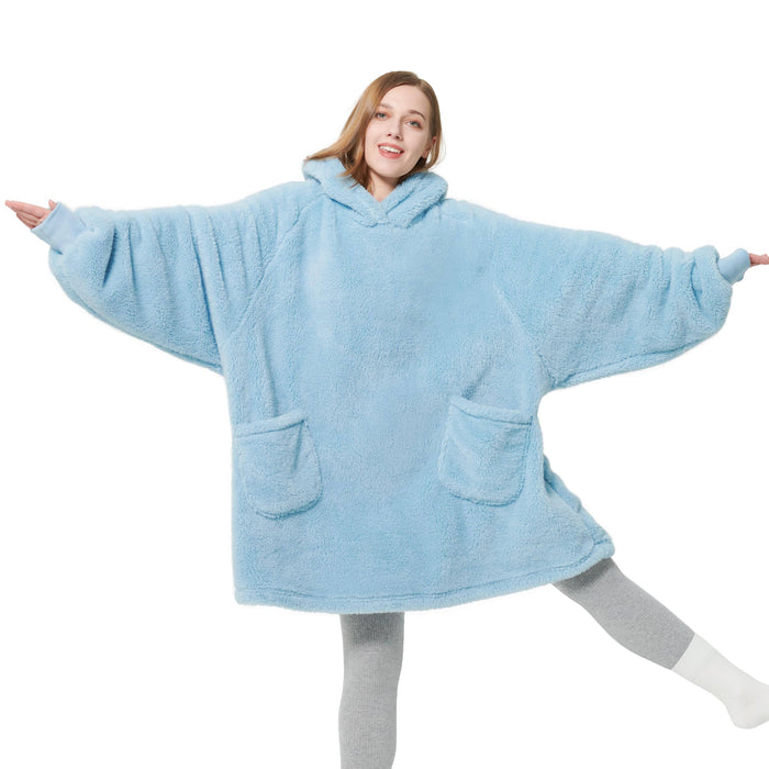 Light blue GentleSoft® oversized shaggy sherpa blanket hoodie with pockets on a smiling woman, product page display.