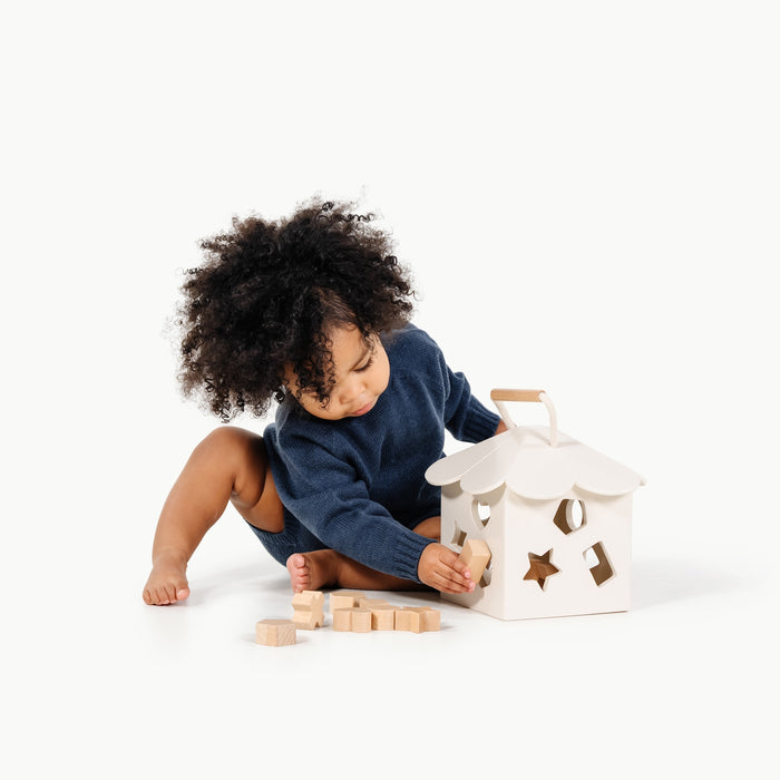 Ivory@Baby using a shape sorter to practice fine motor skills