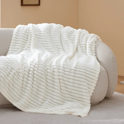 White plush polyester blanket with ribbed texture for a modern cozy bundle.