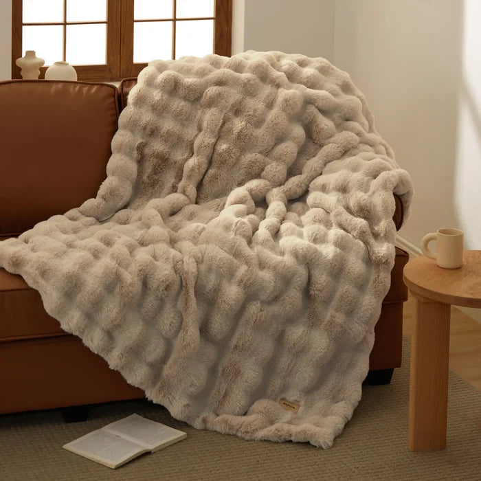 Bedsure luxe plush blanket with ripple texture in warm beige, on sofa.