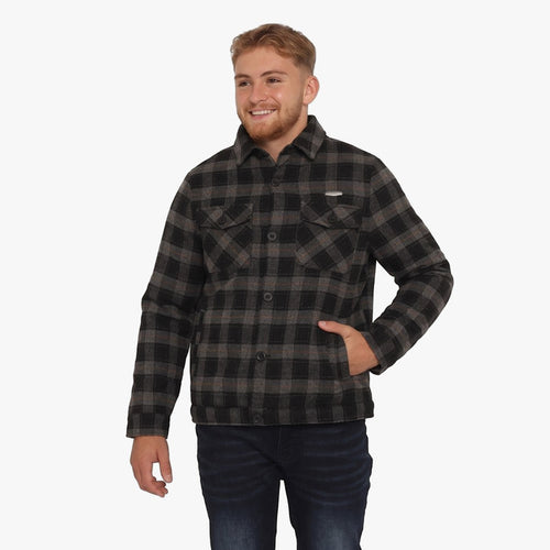 Young man modeling a Soviet Mens Boden Check Jacket in black and grey plaid, paired with dark blue jeans, standing against a