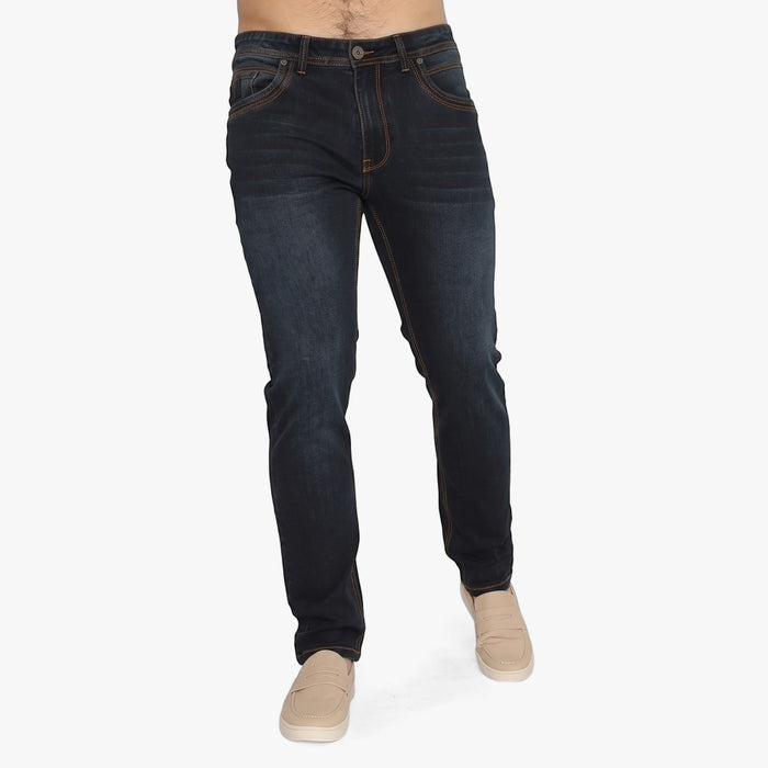 Dark blue-black Soviet Mens Woodford #9 slim leg denim jeans, worn by a man with beige slip-on shoes, showcasing the fit and