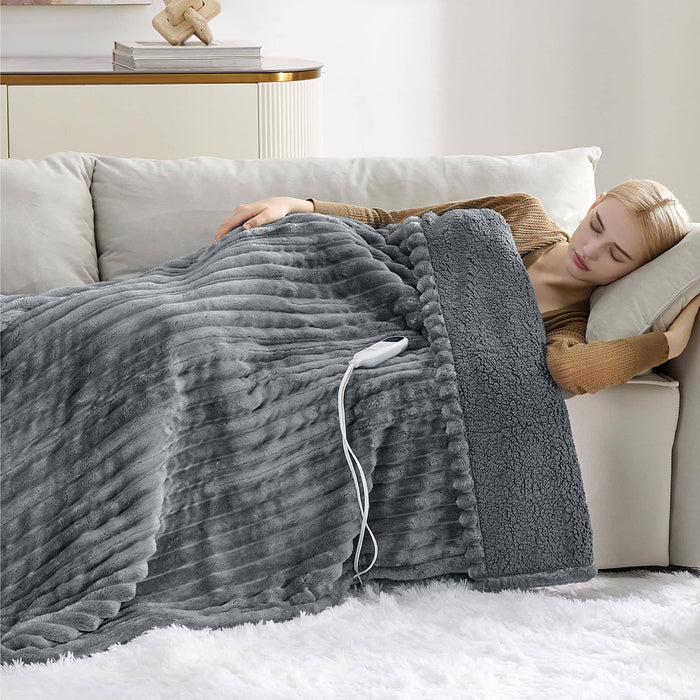 Woman sleeping on couch covered by GentleSoft gray striped flannel heated blanket with sherpa reverse and controller.