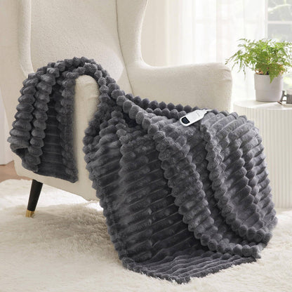 Dark gray textured flannel heated blanket with sherpa reverse draped over armchair, showing controller.