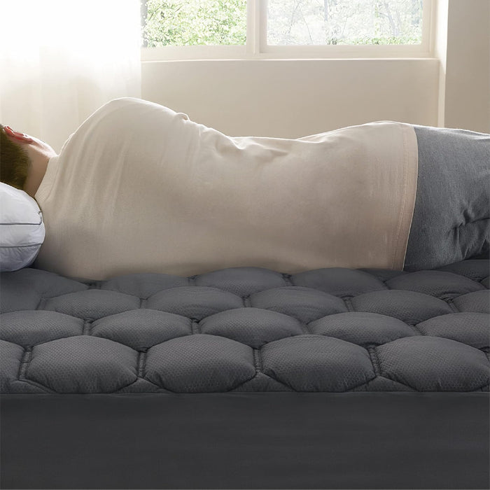 Comfortable dark grey quilted mattress pad featuring three-zone honeycomb pattern.