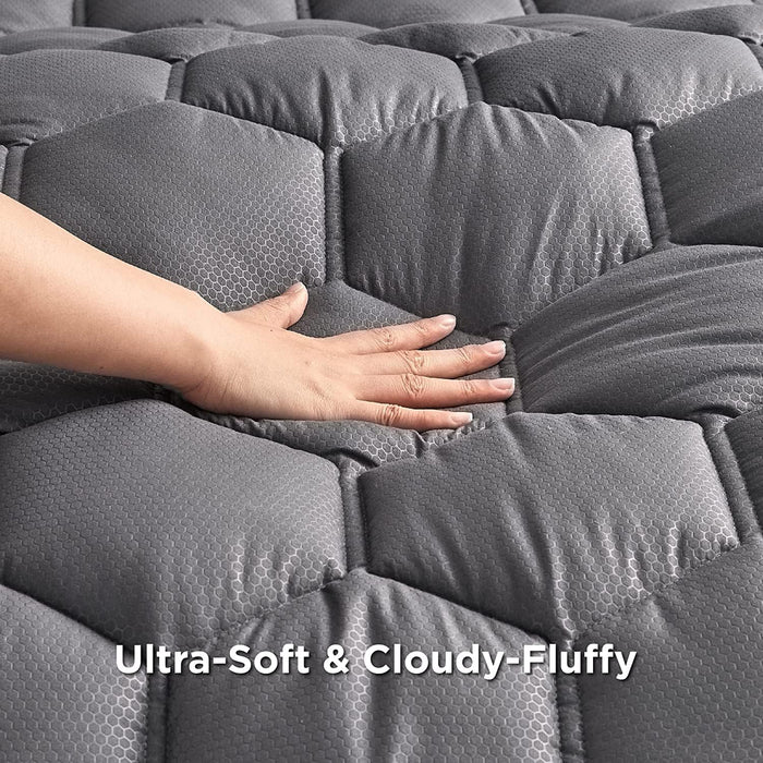 Grey Three-Zone Quilted Mattress Pad with hand demonstrating plush, hexagonal texture and 'Ultra-Soft & Cloudy-Fluffy' text.