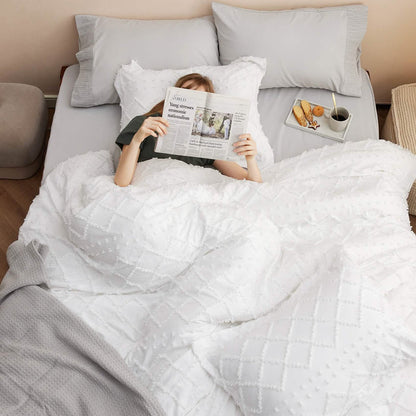 GentleSoft white tufted comforter set with soft diamond embroidery on a bed, creating a cozy and elegant look.