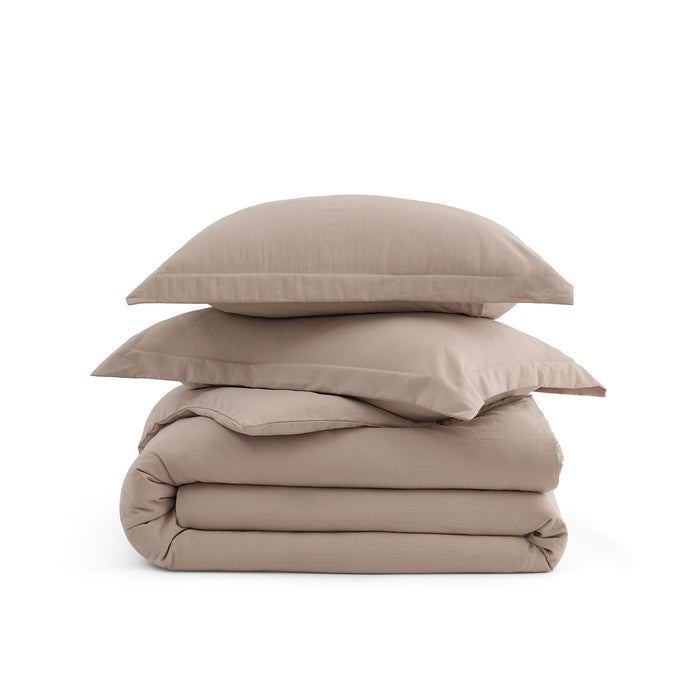 Stack of taupe GentleSoft microfiber duvet cover and pillow shams, showcasing ultra-soft texture.