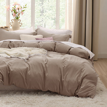 Taupe GentleSoft microfiber duvet cover set on bed with pillows and white throw, creating cozy bedroom.