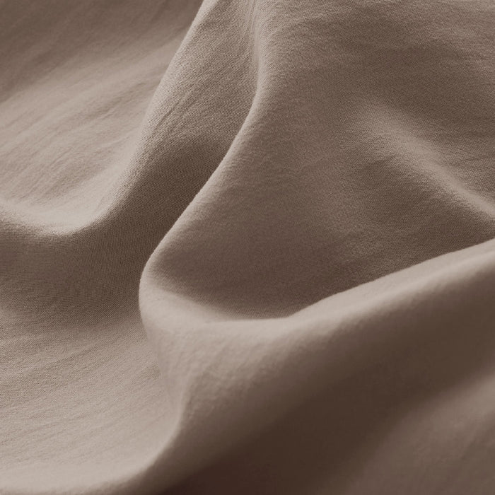 Close-up of taupe GentleSoft microfiber duvet cover fabric, highlighting its soft texture and natural drape.
