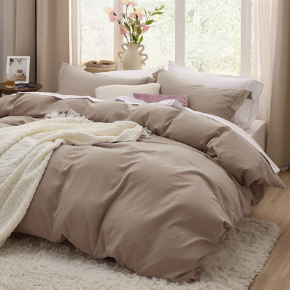 Taupe GentleSoft microfiber duvet cover set on a bed, showing plush texture and cozy bedroom aesthetic.
