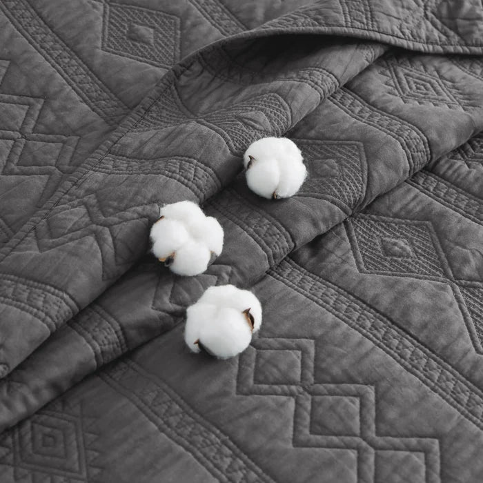 Close-up of grey 100% Cotton Voile Quilt Set featuring textured geometric pattern and cotton bolls.