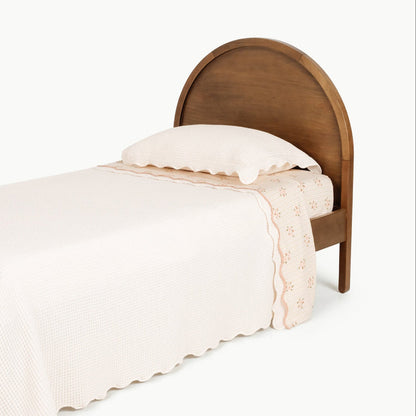 Ivory@Waffle knit coverlet on a child’s bed