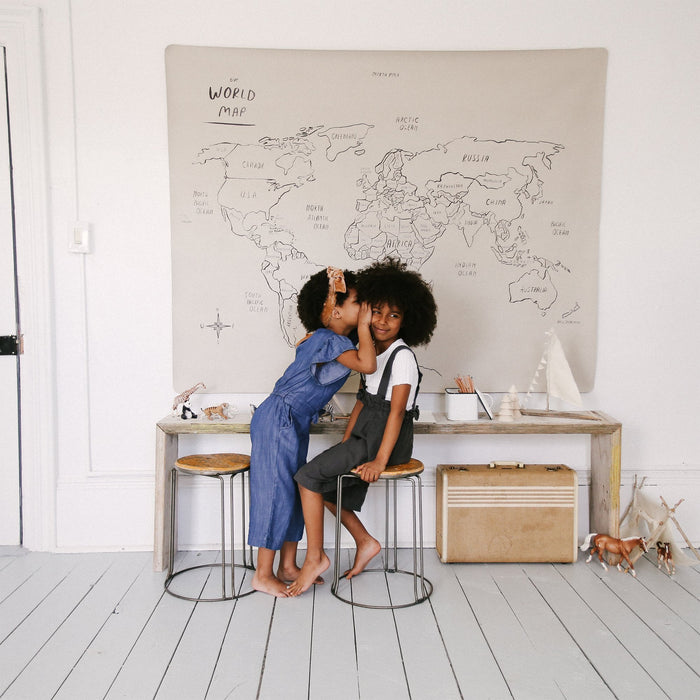 World Map@Midi+ World Map hanging on wall behind to little kids