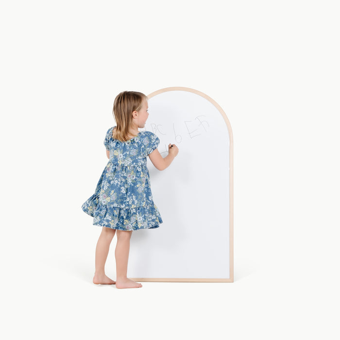 Beech@kid playing on the whiteboard side of the arched chalkboard