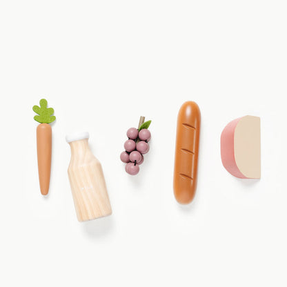 wooden grocery toys laid out in a line, carrot, milk, grapes, bread, cheese