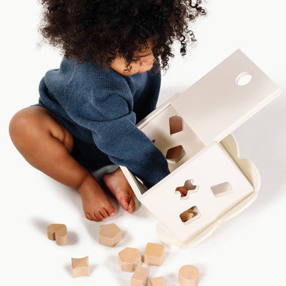 Ivory@Baby using a shape sorter to practice fine motor skills